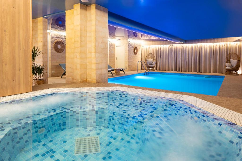 Located just outside the center of Paris, near Mairie de Clichy Metro Station, this stylish hotel features a hot tub, a heated indoor pool, a fitness center and a sauna.