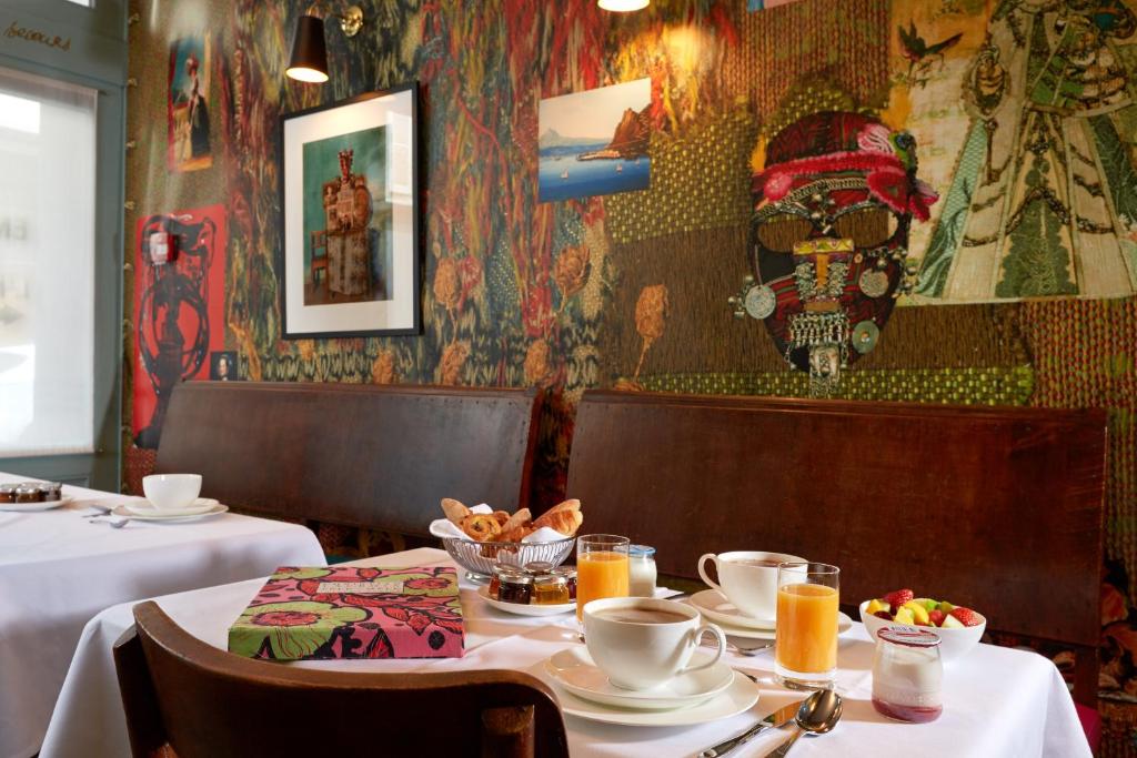 Savor exquisite dining options at Hôtel du Petit Moulin in Paris, where culinary excellence meets artistic ambiance.
