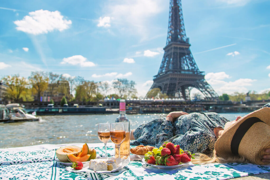 A lovely way to immerse yourself in Parisian culture is to gather delicious food from local markets and picnic by the Seine River.
