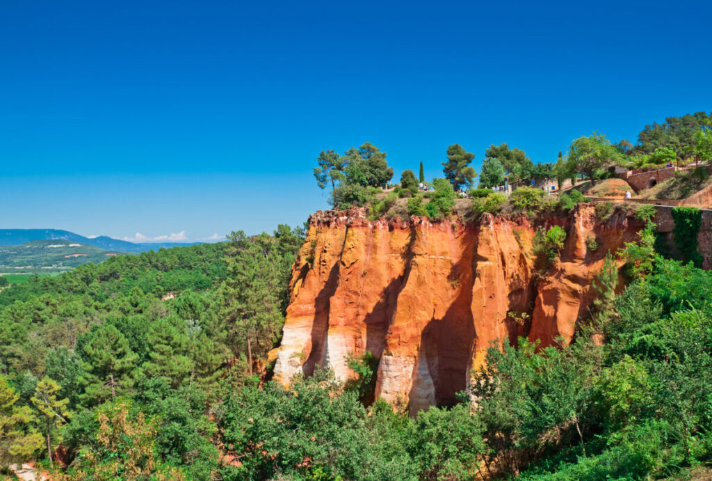 Roussillon, a small, charming village in the South of France, is nestled among stunning red cliffs formed from its ochre-rich quarries. 