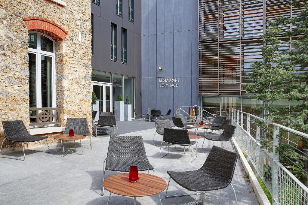 The featured image of Best Western Plus Paris Meudon Ermitage showcases the hotel's modern architecture surrounded by lush greenery, offering a peaceful retreat just outside the bustling city.