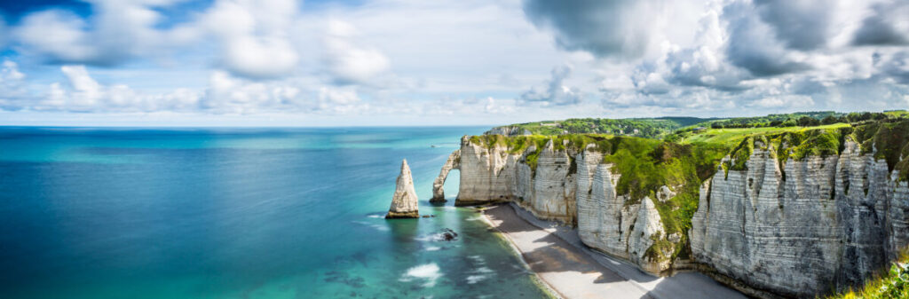 Etretat on the Alabaster Coast in Normandy, France, is renowned for its breathtaking cliffs and natural arches.