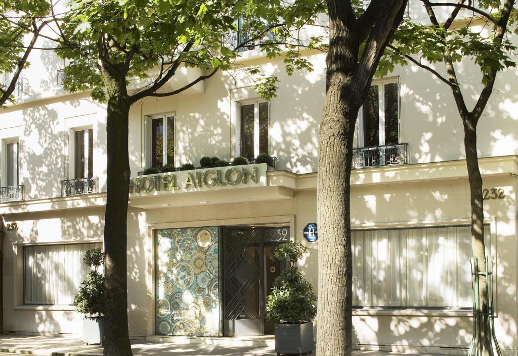 The initial impression of Hôtel Aiglon on Boulevard Raspail in Paris 14 is one of timeless elegance, as the exterior showcases a classic Parisian facade with charming wrought-iron details.