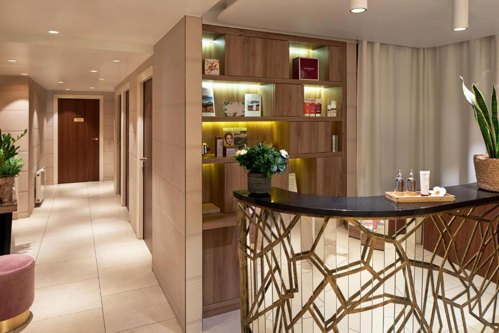 The lobby of Maison Albar - Le Pont-Neuf captivates with its opulent design, seamlessly blending classic and contemporary elements.