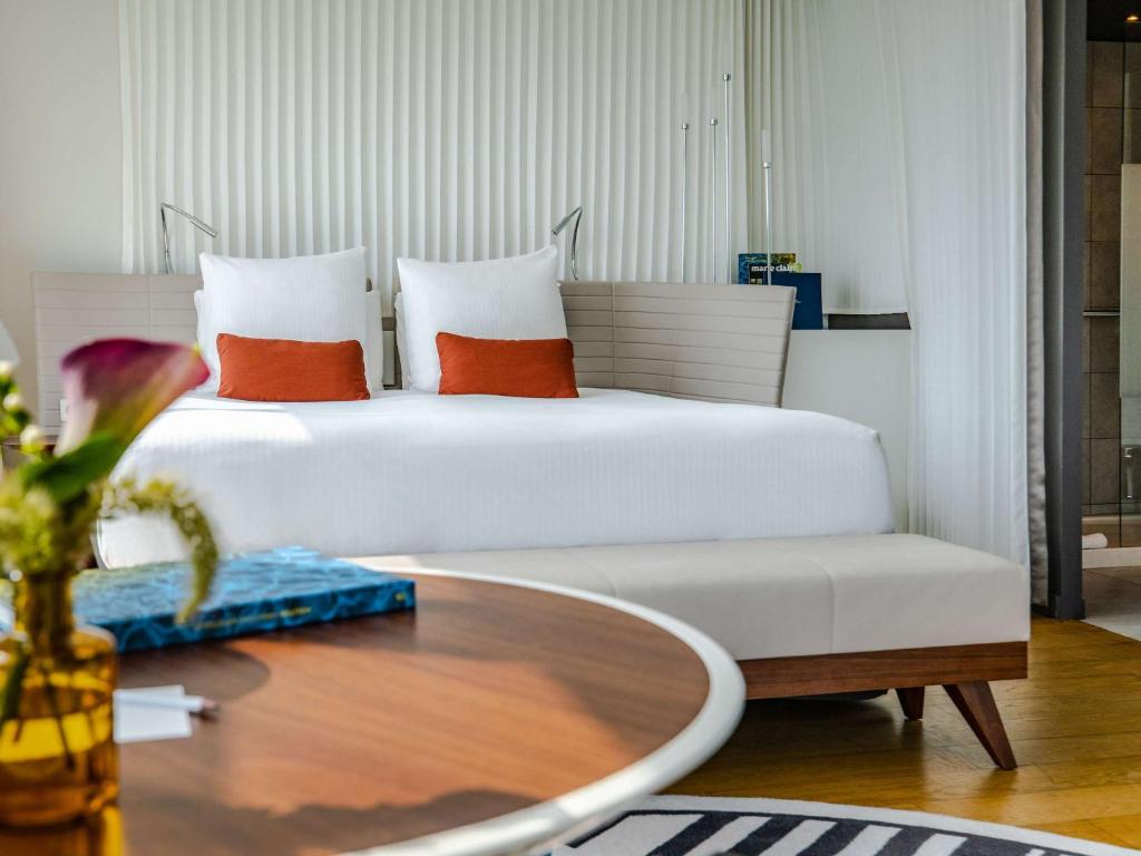 The rooms at Molitor Hotel & Spa Paris MGallery Collection are meticulously designed havens of comfort, boasting luxurious amenities such as plush furnishings, modern technology, and panoramic views of the city.