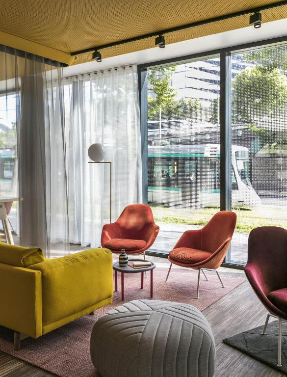 The lobby experience is a harmonious blend of modern aesthetics and warm hospitality, with chic furnishings, ambient lighting, and a welcoming atmosphere.