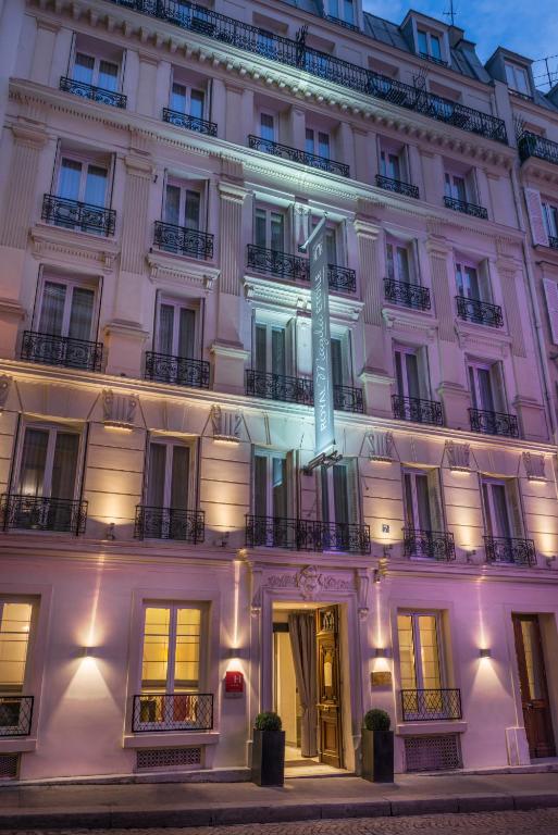 Exterior of Hôtel Magda Champs Elysées Paris, showcasing a grand and elegant facade with intricate architectural details.