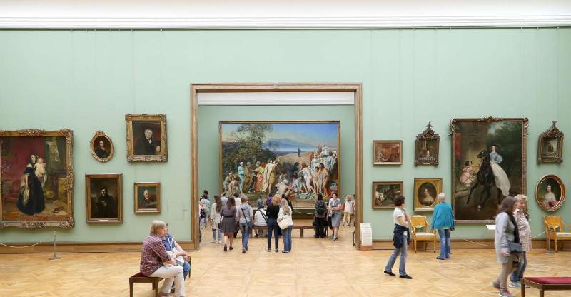 Tourists checking paintings at a museum in Paris