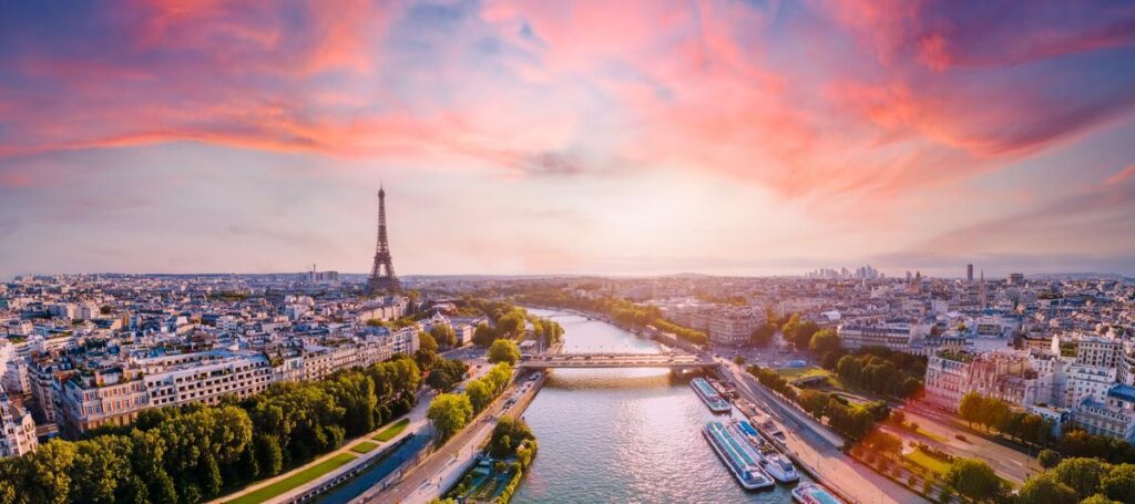 Paris aerial panorama with river Seine and Eiffel tower, France. Romantic summer holidays vacation destination. Panoramic view above historical Parisian buildings and landmarks with sunset sky