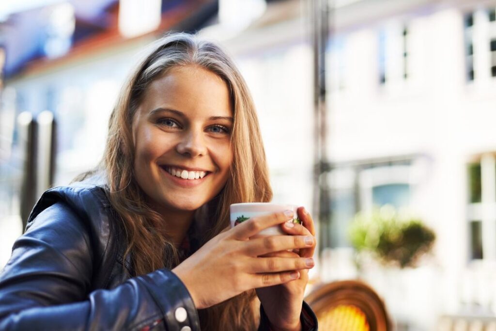 Woman Enjoying Coffee at Parisian Cafe