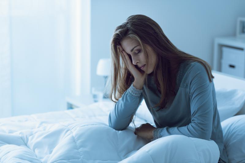 Woman in bed with headache