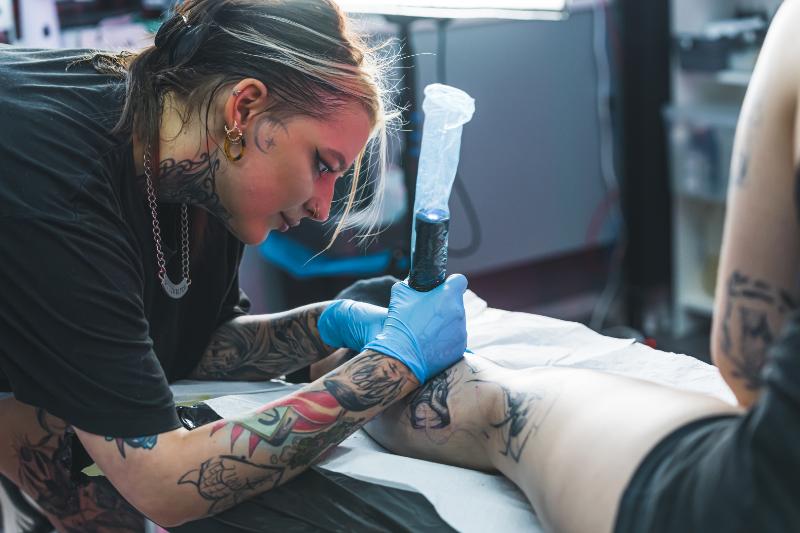 Woman on tattoo session