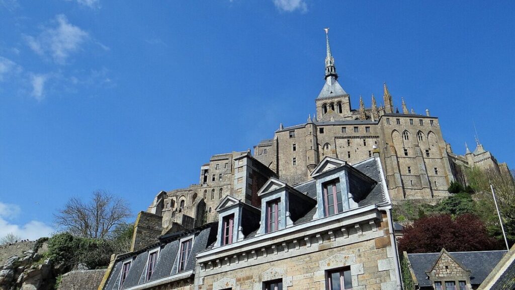 Mont Saint-Michel, a medieval castle and abbey in France, rises dramatically from the sea, showcasing stunning architecture.