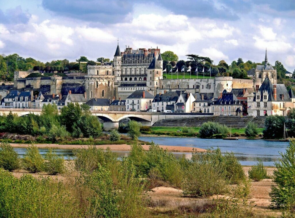 Amboise Castle perched on a hill, with a river flowing below, showcasing a picturesque French landscape.