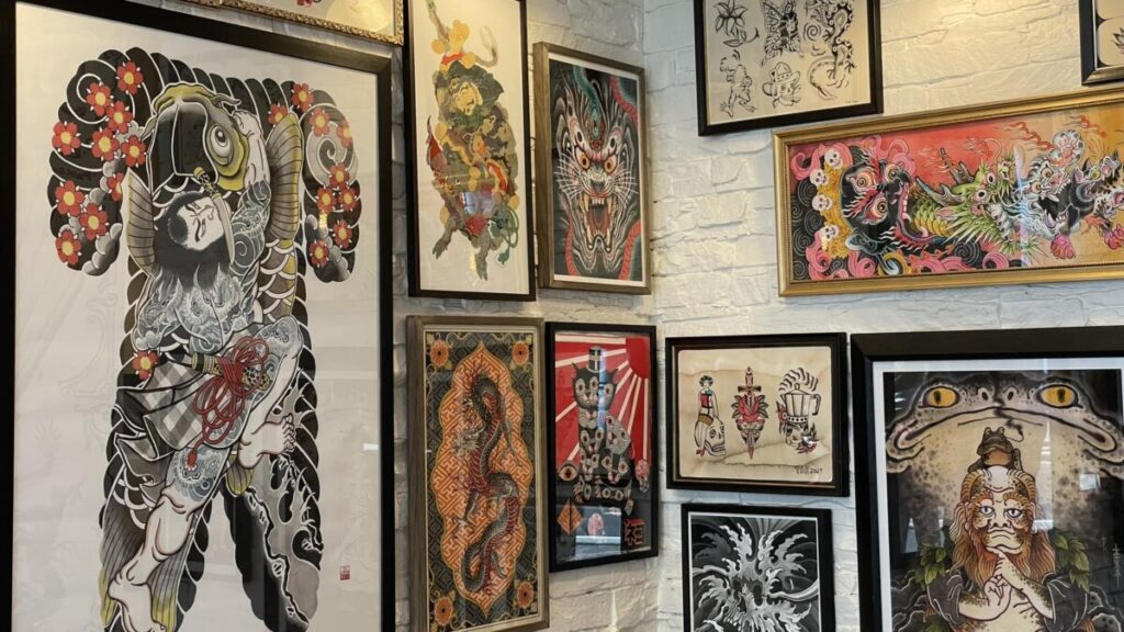 Anomaly Tattoo Shop in Pars features a display of paired tattoo designs