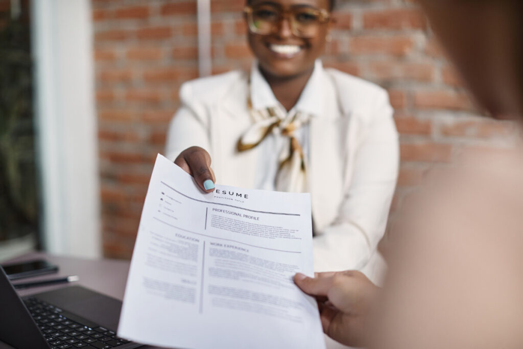 Applicant giving her resume during a job interview