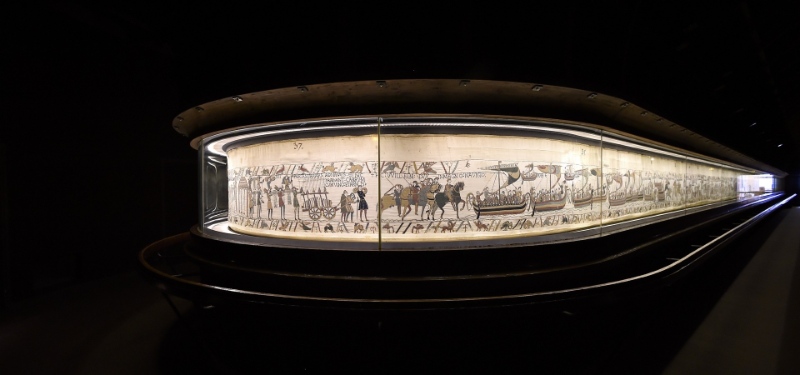 Display case showcasing a significant painting within the Bayeux Tapestry Museum.