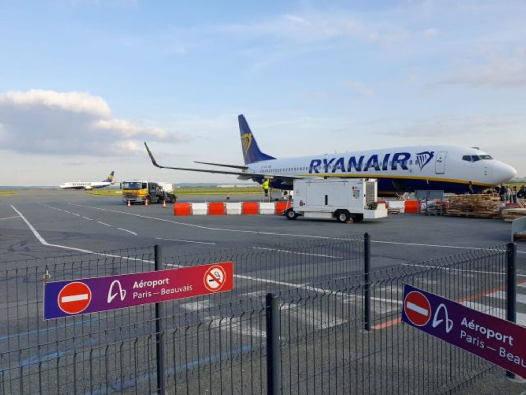 Ryanair Boeing 737-800 parked at Beauvais Airport, showcasing its distinctive blue and yellow livery against a clear sky.