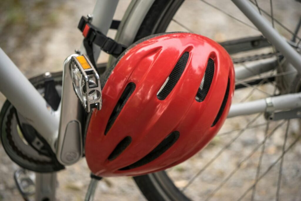 Red bike helmet attached to a bicycle