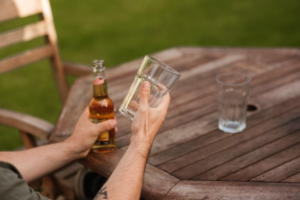 Man with glass and a craft beer bottle