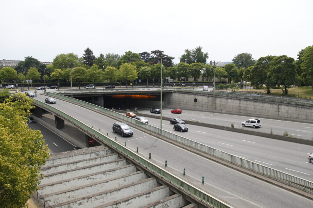 Concrete bridge spanning Boulevard Périphérique in Paris, showcasing urban infrastructure and cityscape.