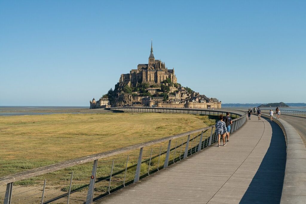 Mont Saint-Michel in Normandy, France, viewed from the bridge leading to the island, showcasing its stunning architecture.