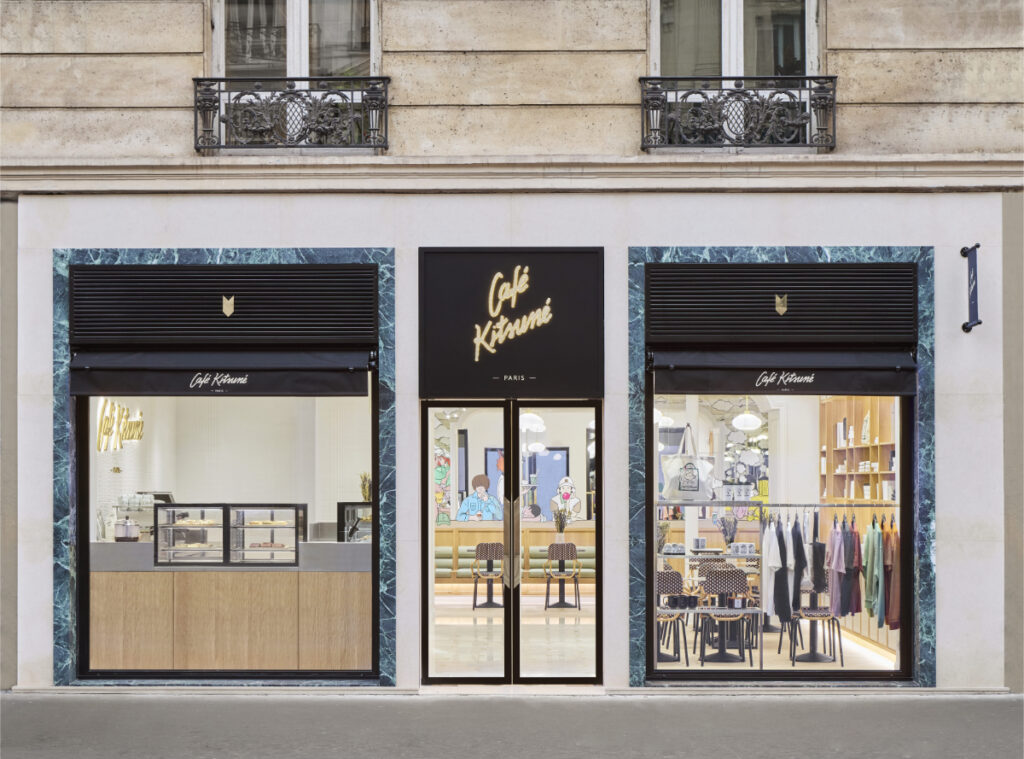 Front view of Café Kitsuné - Opéra in Paris, featuring a large window showcasing the café's inviting interior