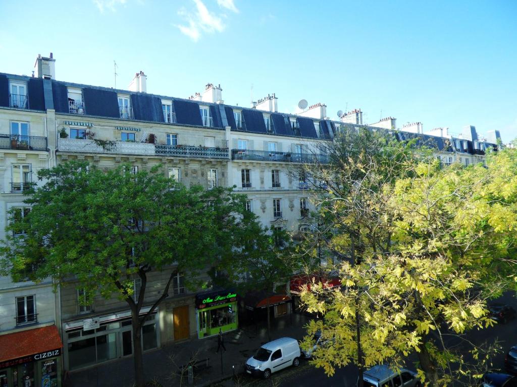 Street view of Camelia Prestige at Place de la Nation, showcasing the bustling atmosphere of Parisian life.