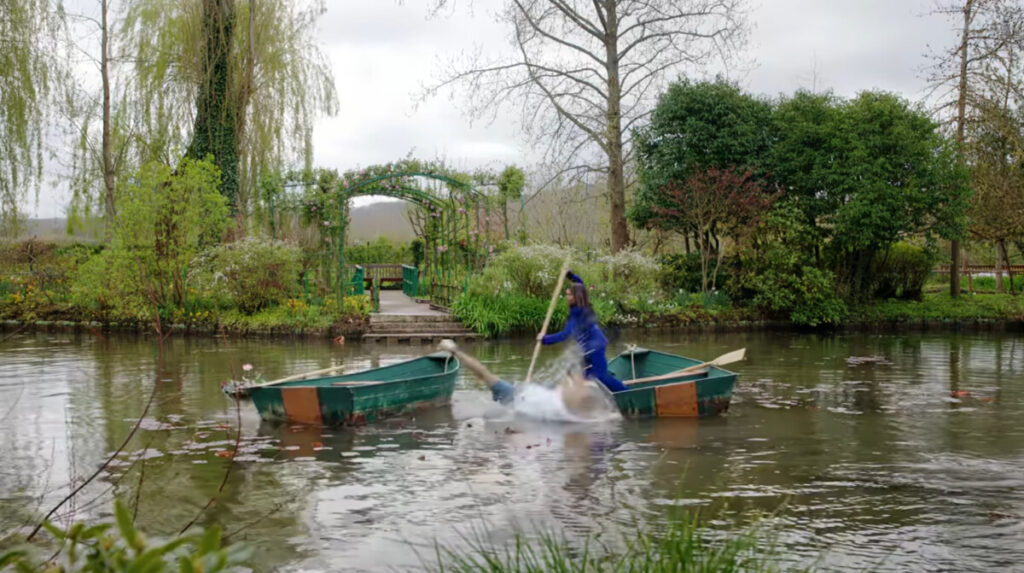 Camille Razat as Camille and Lily Collins as Emily walking through Monet's Garden, Giverny, France, in Emily in Paris, season four, episode two