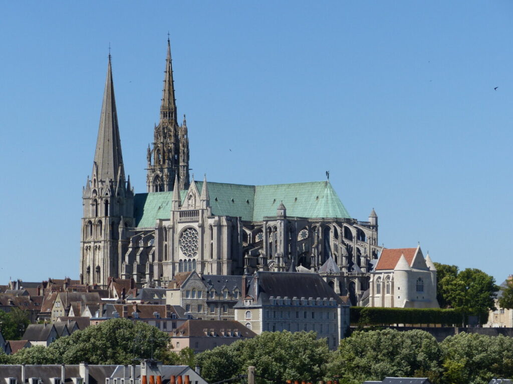 The Cathedral of Our Lady of Chartres, a stunning Gothic structure, showcases intricate stained glass and towering spires.