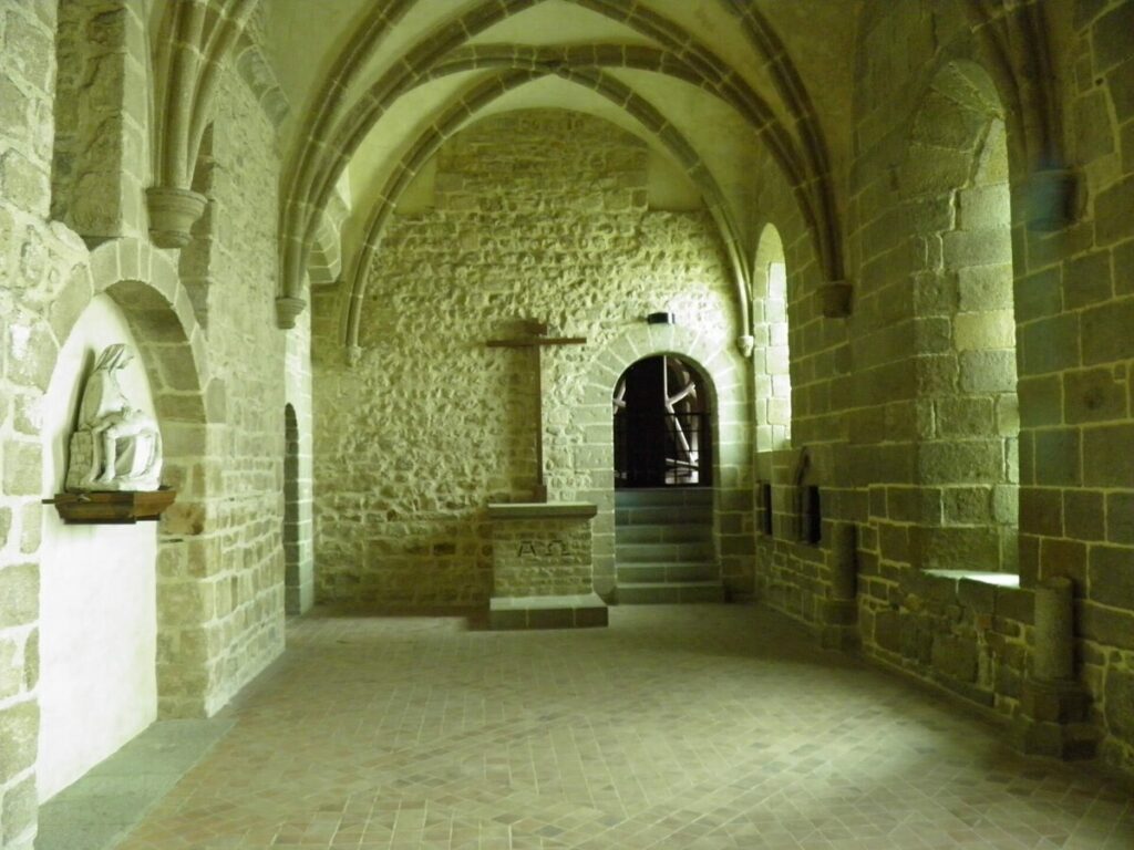 Interior view of Chapelle Saint-Étienne in the Abbey of Mont Saint-Michel, showcasing its historic architecture and serene atmosphere.