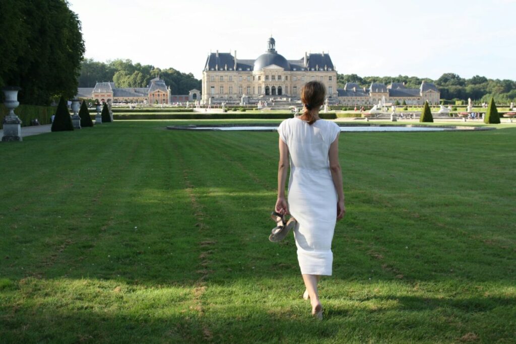 Tourist basking in the beauty of Château de Vaux-le-Vicomte