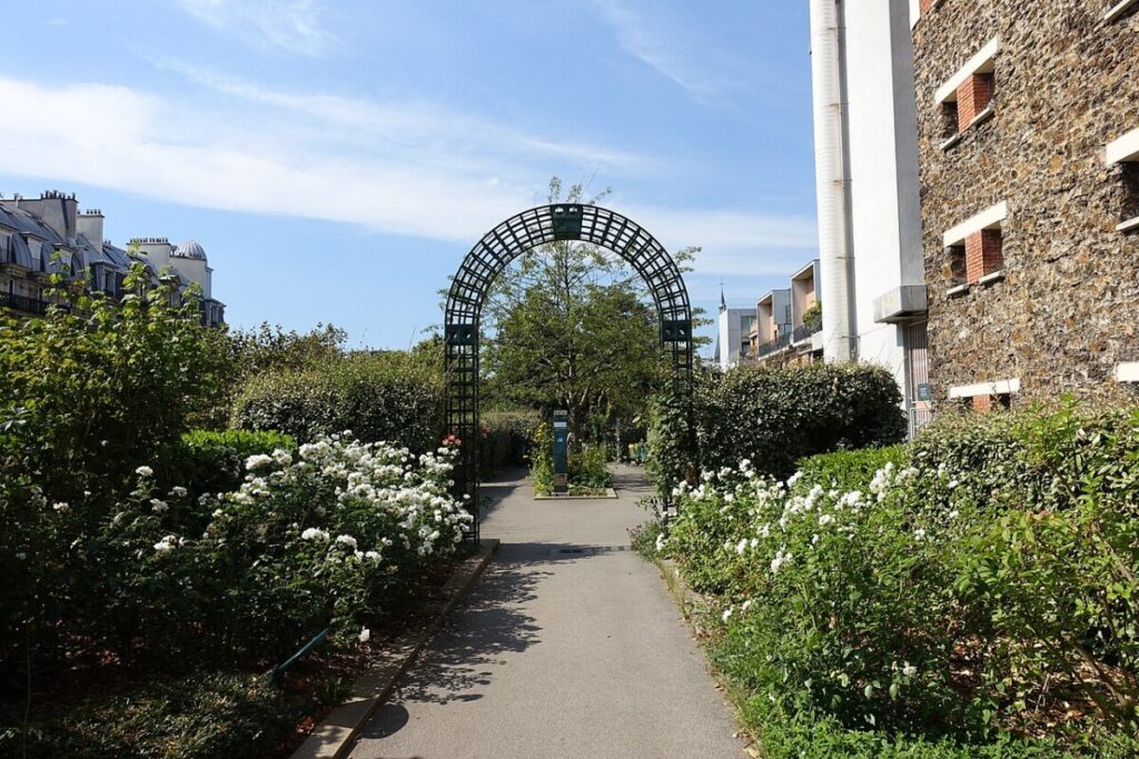 People strolling down the picturesque path of Coulée Verte René-Dumont in Paris, enjoying the lush surroundings.