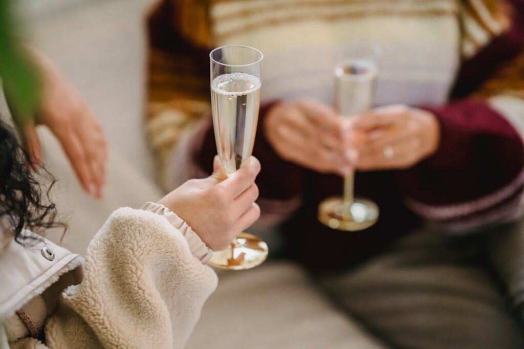 Couple talking with a glass of champagne on their hands