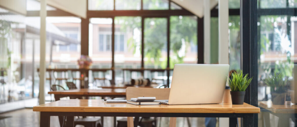 Table with a laptop on a coworking space