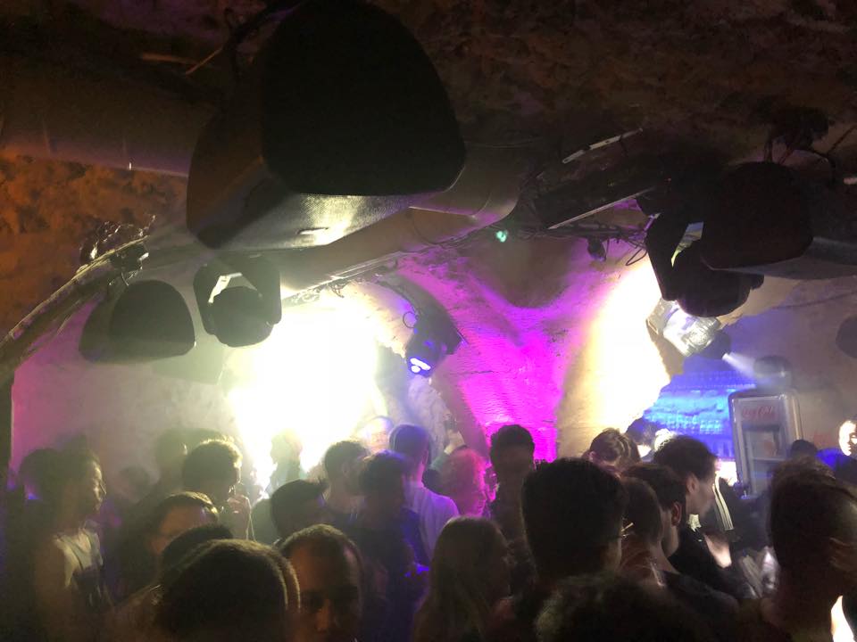 Bustling nightclub scene in CUD, Paris, filled with people enjoying music and dancing.