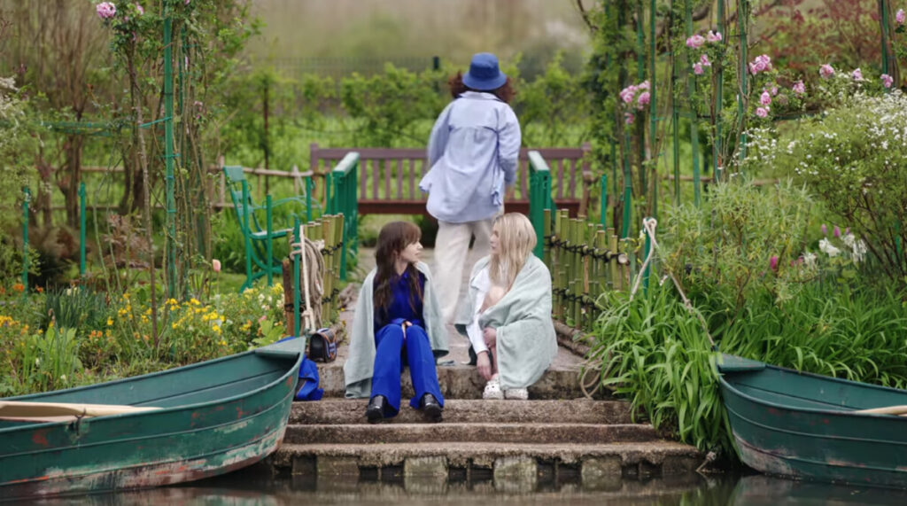 Camille Razat as Camille and Lily Collins as Emily talk in Emily in Paris, season four, episode two