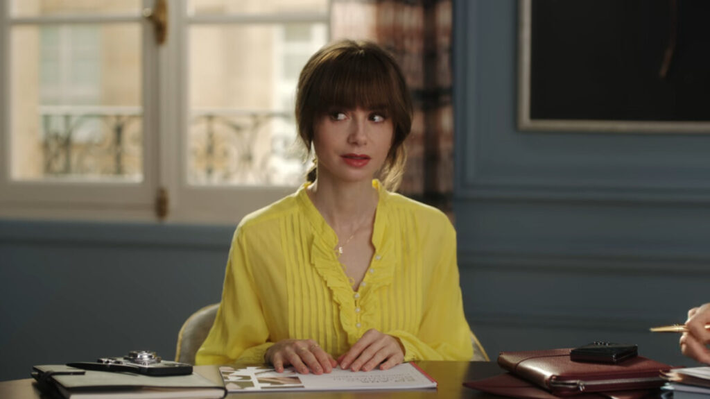 Lily Collins as Emily wearing a yellow clothe in Emily in Paris, season four, episode two