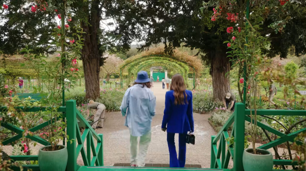 Lily Collins as Emily in Giverny, France, looking for Camille in Emily in Paris, season four, episode two