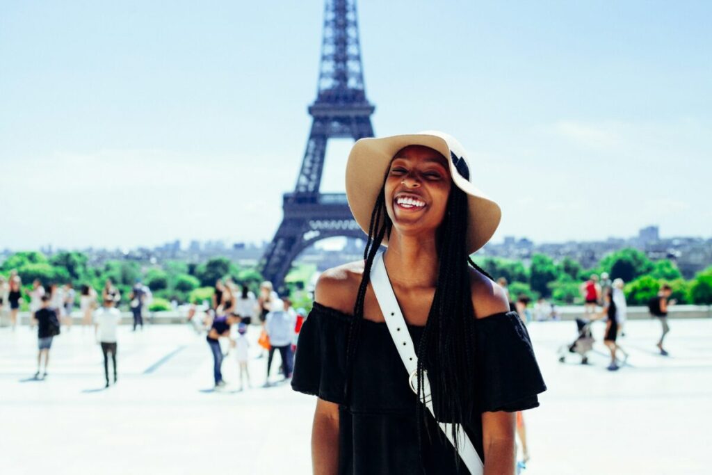 Female traveler dress lighly with a hat in Paris, France