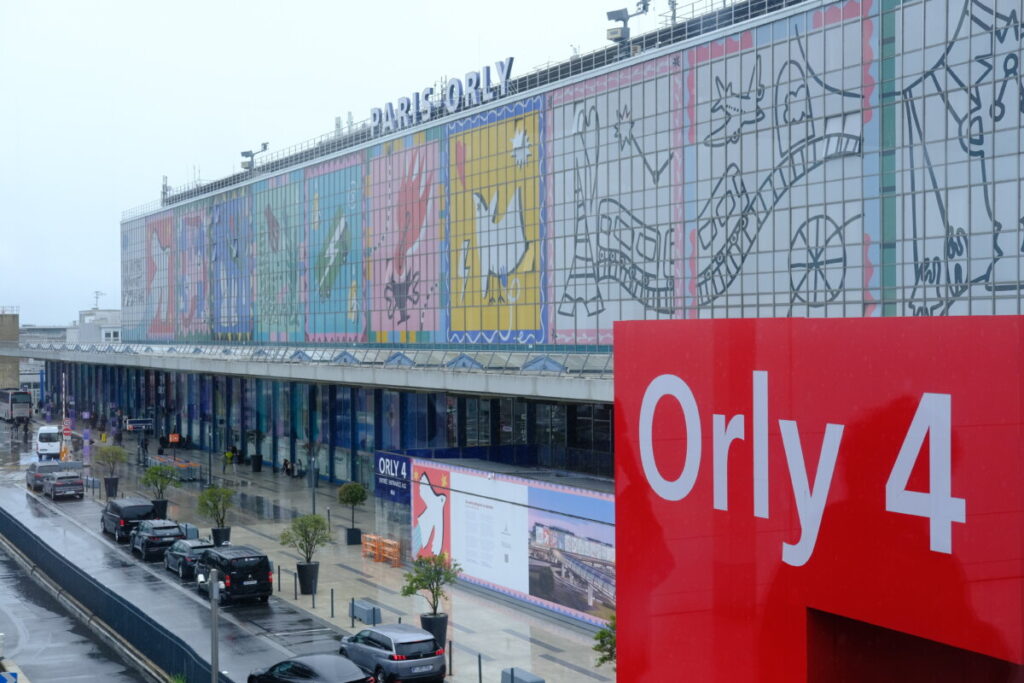Aerial view of Terminal 4 at Orly Airport, showcasing the terminal's architecture and surrounding landscape.
