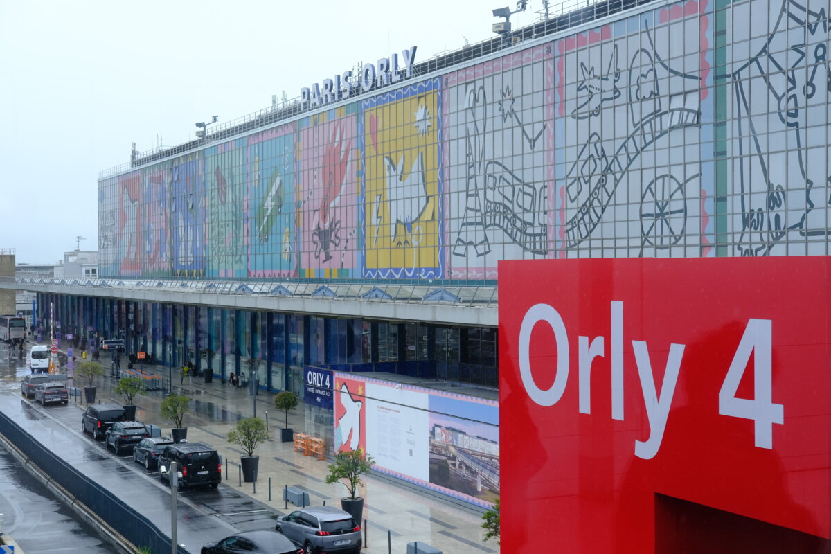 Aerial view of Terminal 4 at Orly Airport, showcasing the terminal's architecture and surrounding landscape.