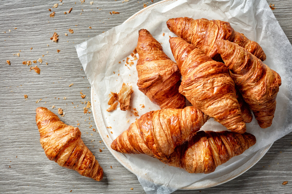 Close-up of freshly baked croissants, showcasing their golden-brown, flaky layers and inviting texture.