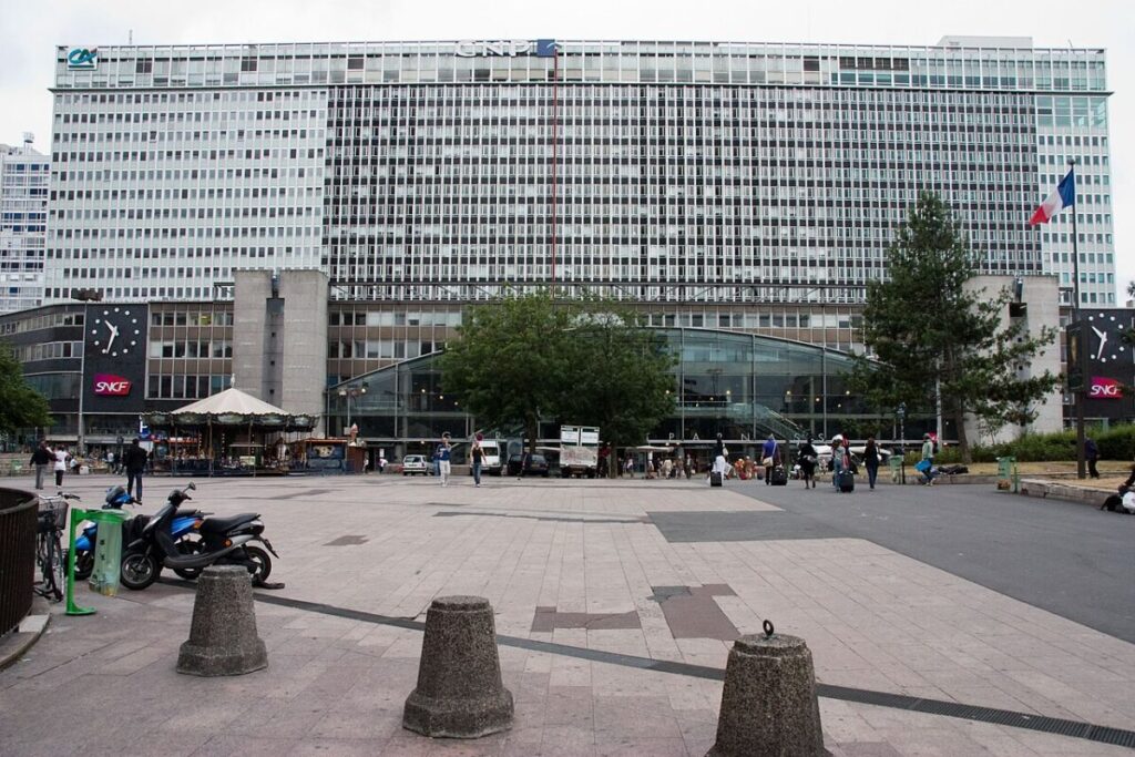 Gare Montparnasse, a prominent building in Paris, features a facade with many windows and a contemporary architectural style.