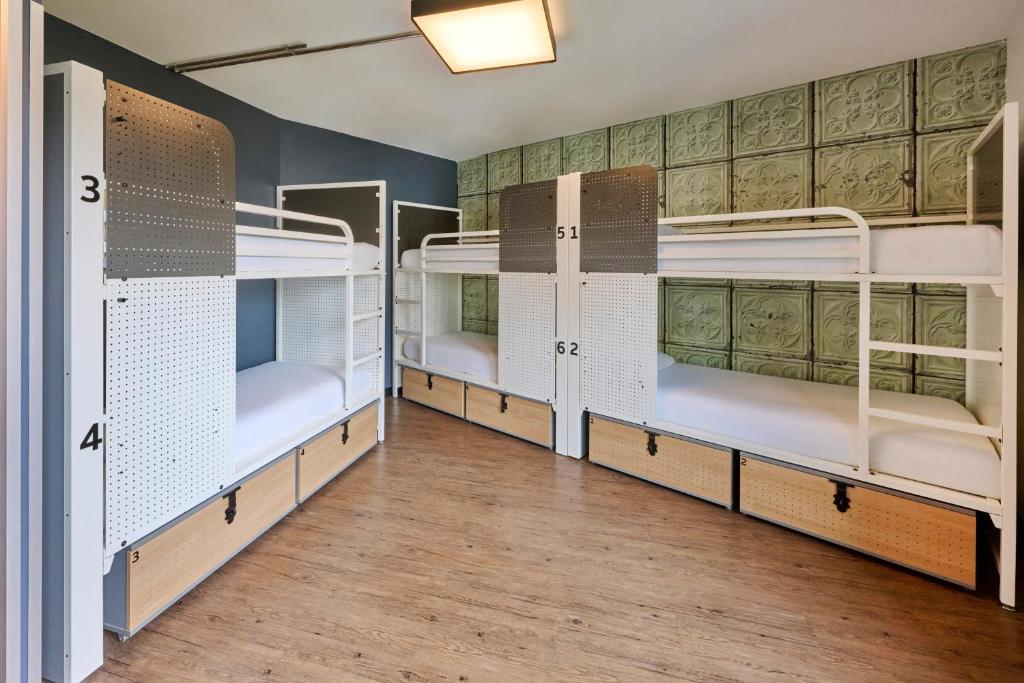 Bunk bed with two beds on a wooden floor in the Generator Paris hostel, located in Paris, France.