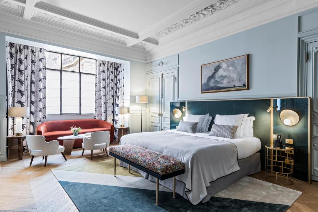 An elegant hotel room with a plush bed, tasteful furnishings, and a sophisticated color palette, exuding comfort and style.
