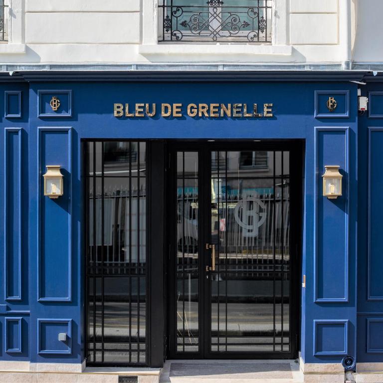 The sleek and modern environment of the Hôtel Bleu de Grenelle's foyer greets visitors with chic furnishings and warm lighting for a welcoming first impression.