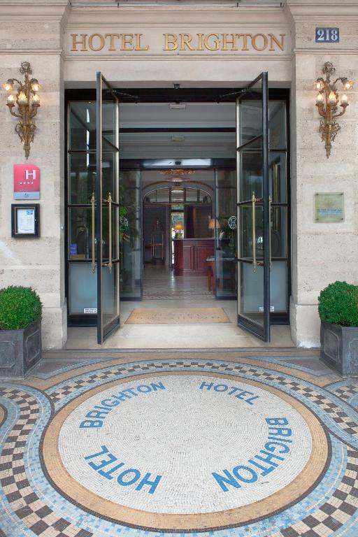 Stunning facade of Hôtel Brighton - Esprit de France, featuring classic Parisian architecture with ornate details and tall windows overlooking the Tuileries Garden.