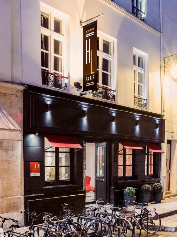 Hôtel de Lille welcomes guests with timeless elegance, as seen in its charming façade and inviting entrance.
