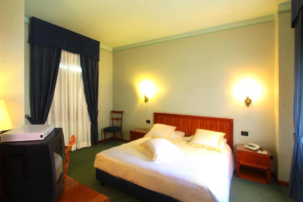 Hotel De Paris Bedroom: Elegant hotel bedroom with luxurious furnishings and soft lighting.